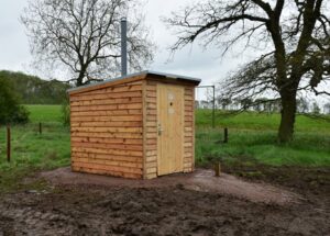 A NatSol Zero Discharge toilet and NatSol timber building on a remote site
