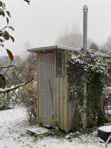 Compact toilet in snow. Waterless toilets have no freezing risk.